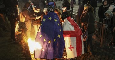 Supporters of the Georgian opposition light fire during a demonstration in front of the Parliament building in Tbilisi, Georgia, Dec. 4, 2024. (EPA Photo)