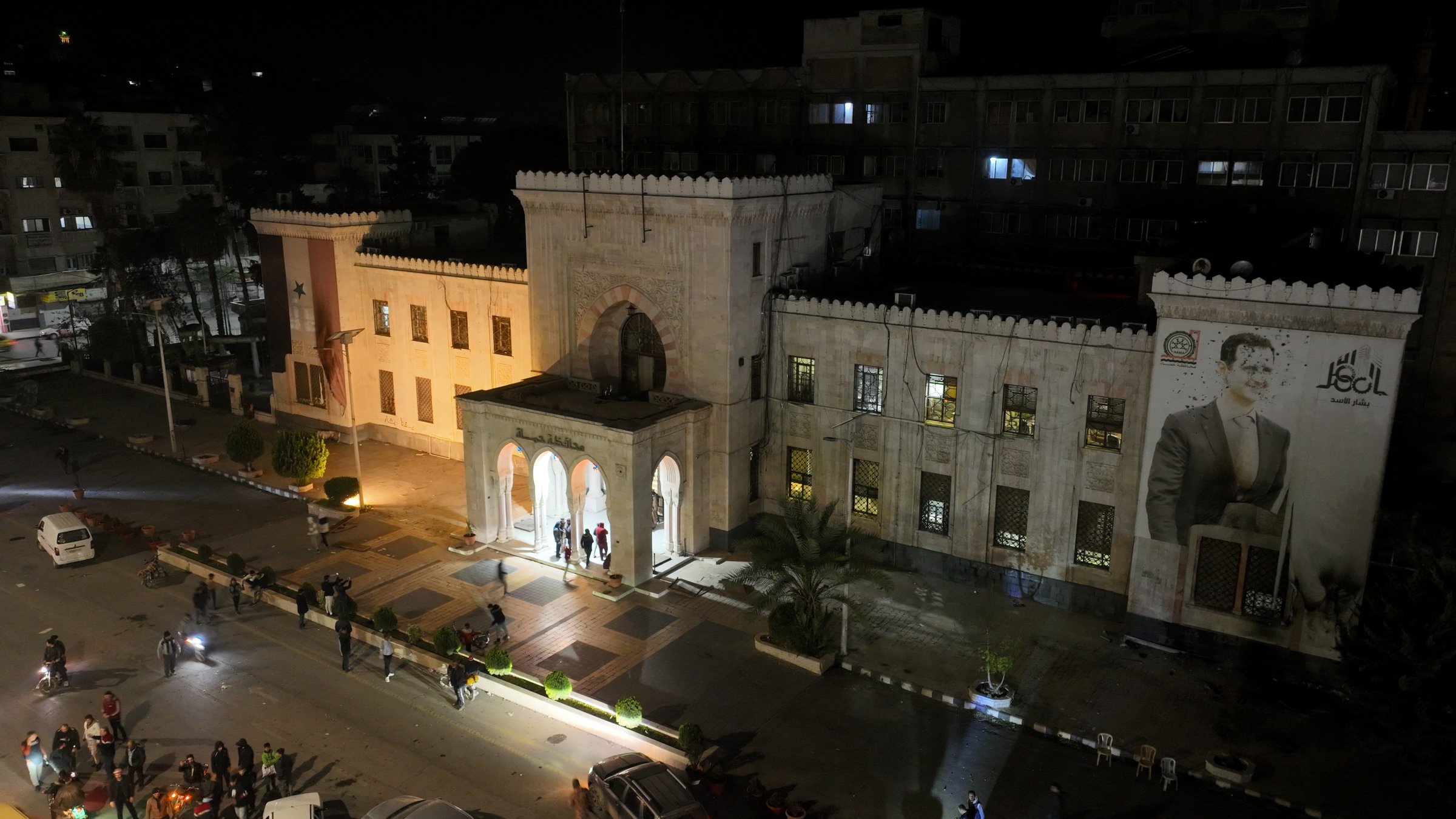 A drone view shows people gathering in front of Hama governor&#039;s building with an image of Syrian President Bashar Assad after anti-regime forces captured the city during their advance across northern Syria, in Hama, Syria, Dec. 5, 2024. (Reuters Photo)