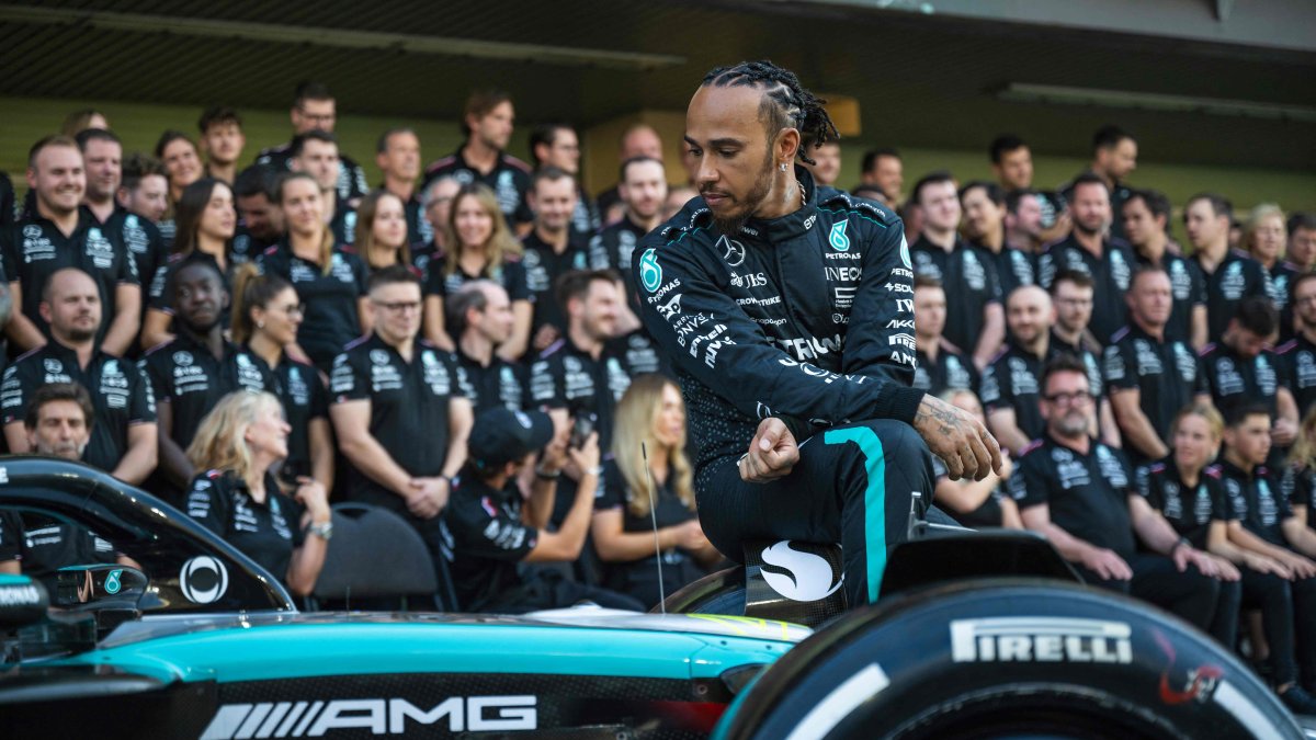 Mercedes&#039; British driver Lewis Hamilton sits on his car as he arrives to pose for a group photo with his team ahead of the Abu Dhabi Formula One Grand Prix at the Yas Marina Circuit, Abu Dhabi, UAE, Dec. 5, 2024. (AFP Photo)