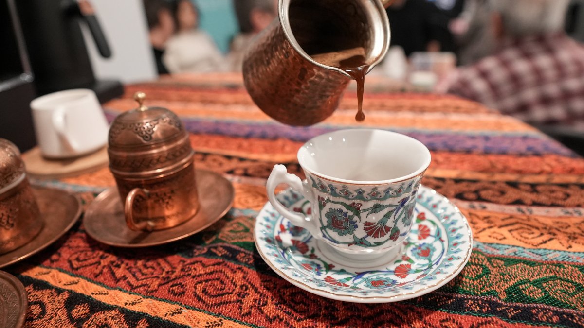 A Turkish coffee is poured from a &quot;cezve&quot; – a traditional long-handled pot used to brew coffee – into a classic coffee cup during the World Turkish Coffee Day event at the Yunus Emre Institute in Toronto, Canada, Dec. 5, 2024. (AA Photo)