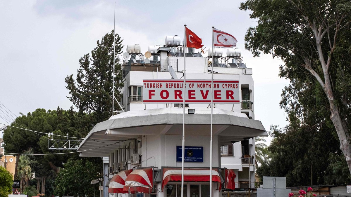 Flags of Türkiye and the Turkish Republic of Northern Cyprus (TRNC) fly above a checkpoint controlled by the TRNC leading to the U.N. buffer zone on the island, in the northern part of the divided capital Lefkoşa (Nicosia), Turkish Cyprus, July 11, 2024. (AFP Photo)