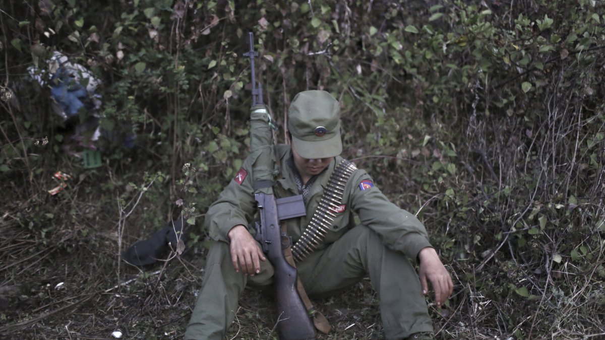 A rebel soldier with the Myanmar National Democratic Alliance Army (MNDAA) rests in a camp in the Kokang region of Myanmar across from the Chinese border town of Zhenkang, Yunnan province, China, March 10, 2015. (AP Photo)