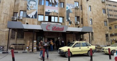 People are seen outside Aleppo University Hospital, badly damaged by regime airstrikes, after anti-regime fighters captured the city, Aleppo, Syria, Dec. 4, 2024. (AA Photo)