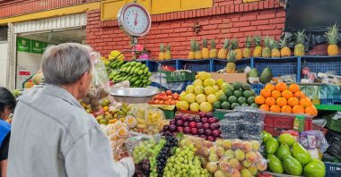 A person sells food in a market square, Bogota, Colombia, Dec. 1, 2024. (Reuters Photo)