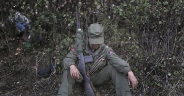 A rebel soldier with the Myanmar National Democratic Alliance Army (MNDAA) rests in a camp in the Kokang region of Myanmar across from the Chinese border town of Zhenkang, Yunnan province, China, March 10, 2015. (AP Photo)