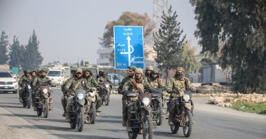 Anti-regime fighters ride motorbikes into the center of Homs city, after seizing several towns around it, during their advance, Homs, Syria, Dec. 6, 2024. (AA Photo)