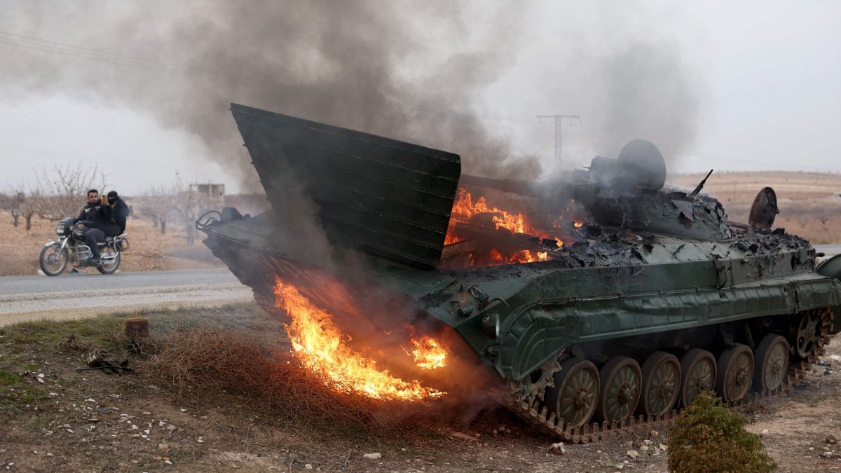 A military vehicle belonging to Syrian regime forces burn in the Hama governorate, Syria, Dec. 7, 2024. (AFP Photo)