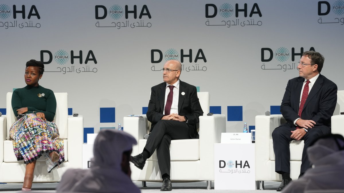 Treasury and Finance Minister Mehmet Şimşek (C) attends a panel at Doha Forum 2024, Doha, Qatar, Dec. 7, 2024. (AA Photo)