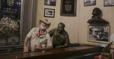 A man dressed like the late American writer Ernest Hemingway poses for a photo, recalling passages from the life and work of 1954 Nobel Prize-winning writer Ernest Hemingway, Havana, Cuba, Dec. 6, 2024. (AP Photo)