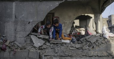 Two Palestinian brothers inspect the rubble of a damaged building following Israeli airstrikes in Al Nuseirat refugee camp, central Gaza Strip, Palestine, De. 7, 2024. (EPA Photo)