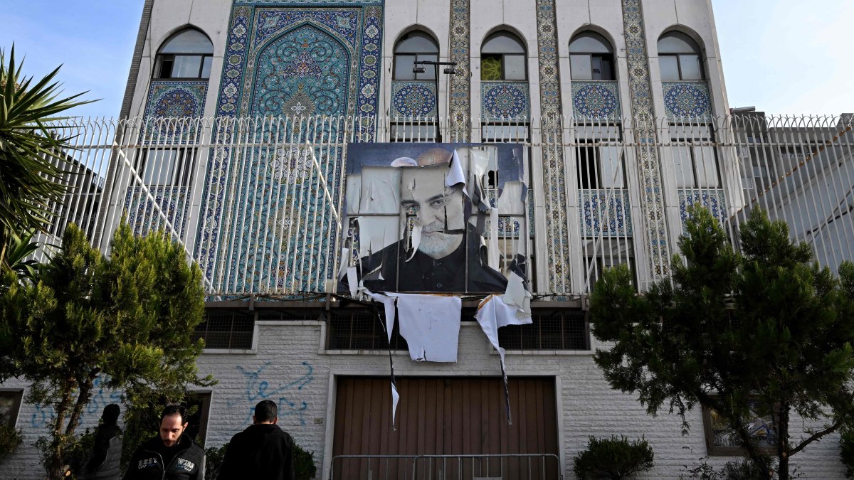 Syrian men stand outside the building of the Iranian embassy which was ransacked after anti-regime fighters took Damascus, Syria, Dec. 9, 2024. (AFP Photo)