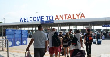 Tourists are photographed in front of a sign reading &quot;Welcome to Antalya,&quot; Antalya, southern Türkiye. (IHA File Photo)