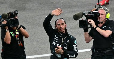 Mercedes' British driver Lewis Hamilton greets fans after the Abu Dhabi Formula One Grand Prix at the Yas Marina Circuit, Abu Dhabi, UAE, Dec. 8, 2024. (AFP Photo)