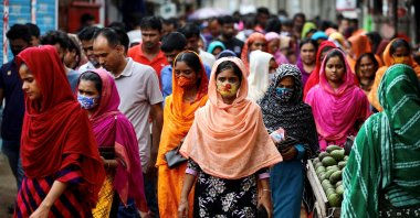 Garment workers come out of a factory during lunch break as factories remain open despite a countrywide lockdown, Dhaka, Bangladesh, July 6, 2021. (Reuters Photo)