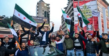 Syrian and Lebanese people celebrate after the Syrian opposition declared that they had taken the Syrian capital in a lightning offensive, sending regime leader Bashar Assad fleeing and ending six decades of Baath rule in Syria, Tripoli, Lebanon, Dec. 9, 2024. (AFP Photo)