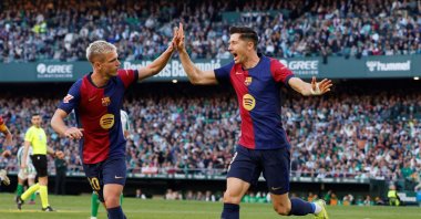 Barcelona&#039;s Robert Lewandowski (R) celebrates scoring their first goal with Dani Olmo during the La Liga match against Real Betis at the Estadio Benito Villamarin, Seville, Spain, Dec. 7, 2024. (Reuters Photo)