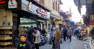 People shop at a market, Damascus, Syria, Dec. 9, 2024. (AFP Photo)
