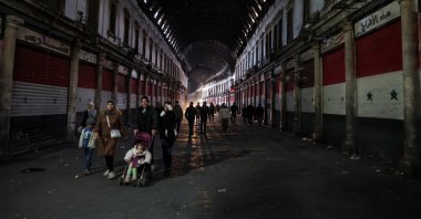 People walk next to closed shops after opposition forces seized the capital and ousted Bashar Assad in Damascus, Syria, Dec. 9, 2024. (Reuters Photo)