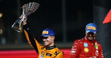 McLaren&#039;s Lando Norris celebrates on the podium with a trophy after winning the Abu Dhabi Grand Prix, Abu Dhabi, UAE, Dec. 8, 2024. (Reuters Photo)