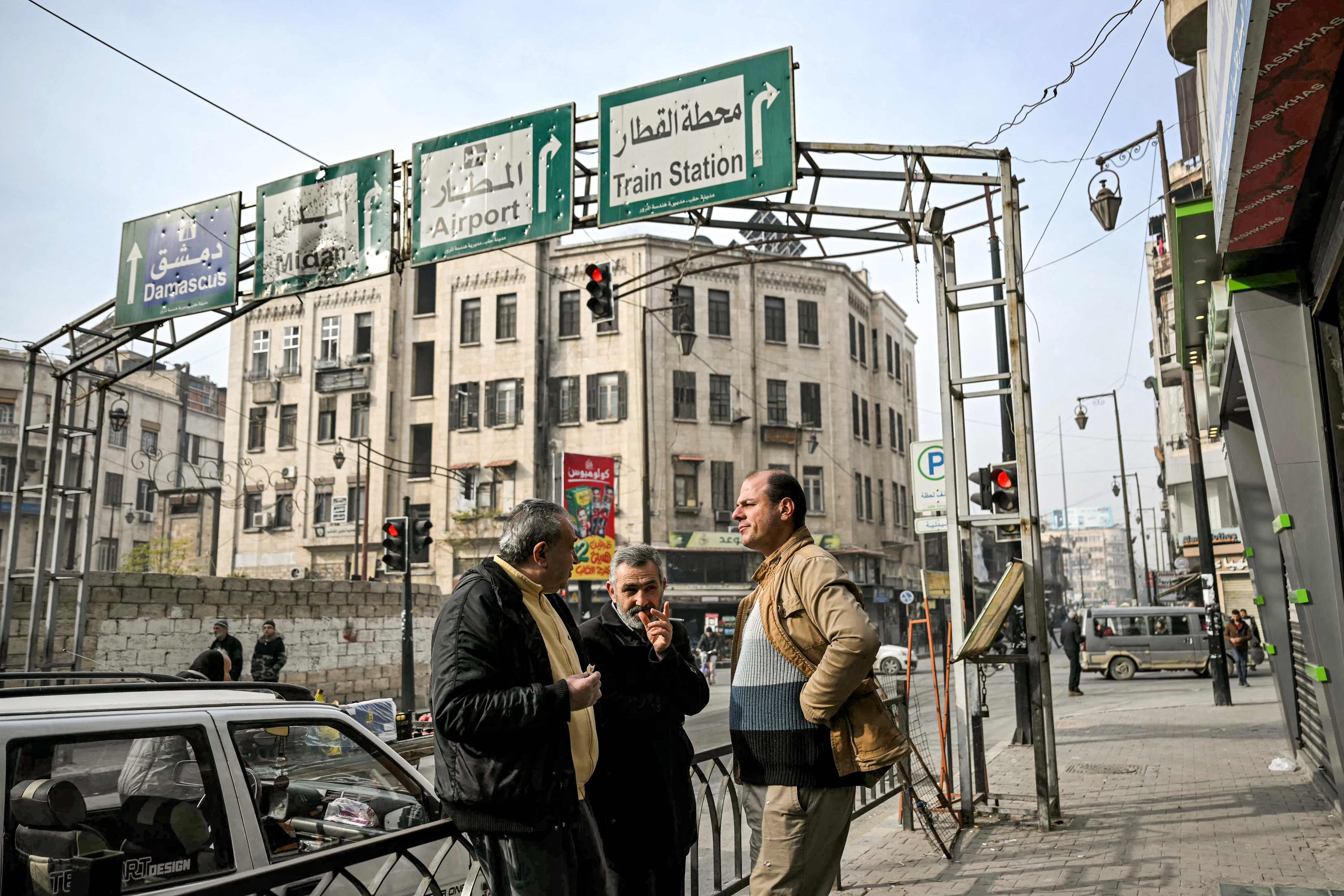 Men stand together to chat along a street in Aleppo, northern Syria, Dec. 11, 2024. (AFP Photo)