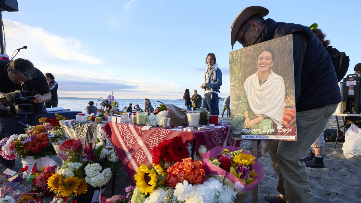 Photo of Ezgi Eygi stands next to flowers at a vigil in Seattle, U.S., Sept. 11, 2024. (AP Photo)