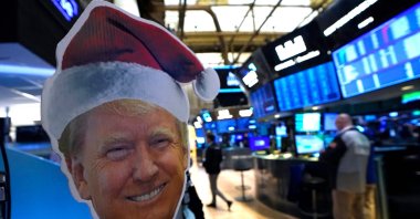 An image of U.S. President-elect Donald Trump is displayed as traders and financial professionals work on the floor of the New York Stock Exchange (NYSE) at the opening bell, New York City, U.S., Nov. 26, 2024. (AFP Photo)