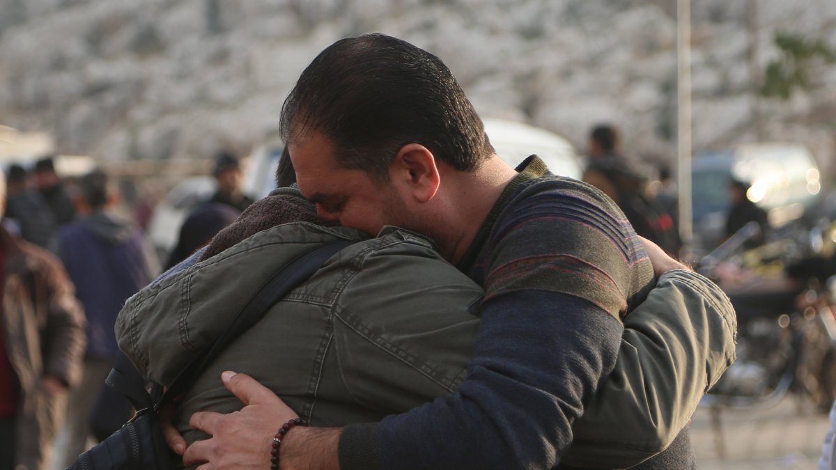 Syrian men embrace each other after arriving from Türkiye through the Bab al-Hawa border crossing, Idlib, Syria, Dec. 11, 2024. (EPA Photo)
