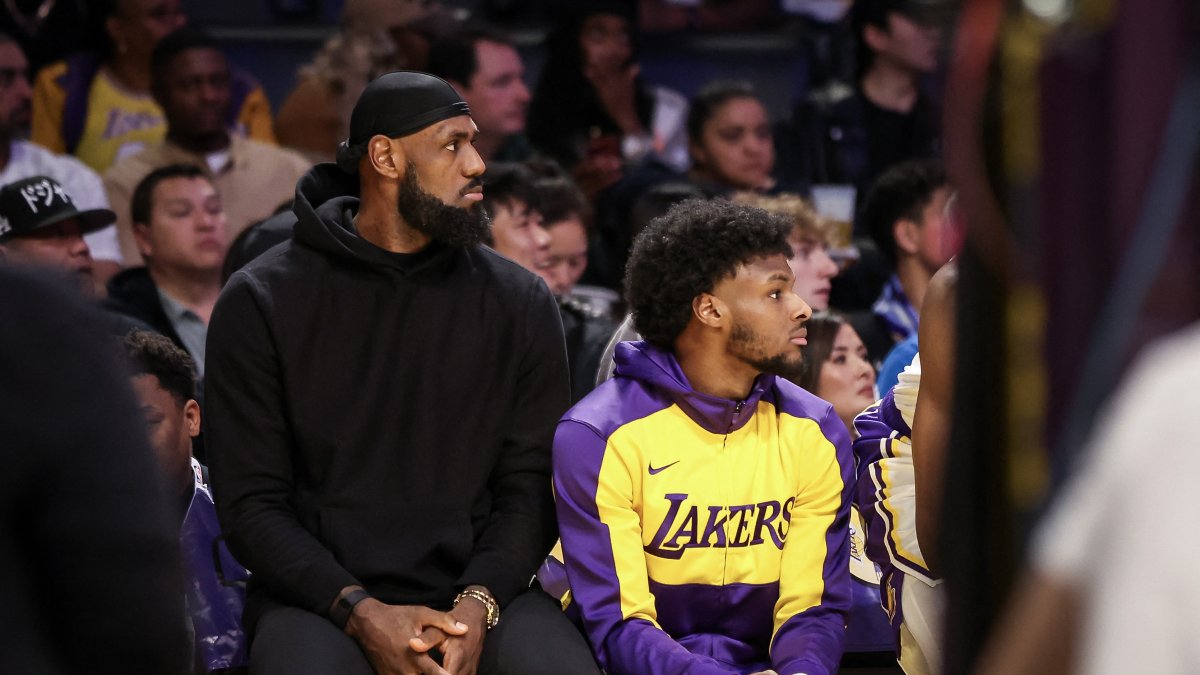 LeBron James (L) and Bronny James of the Los Angeles Lakers look on from the bench in the first half against the Portland Trail Blazers at Crypto.com Arena, Los Angeles, California, U.S., Dec. 8, 2024. (AFP Photo)