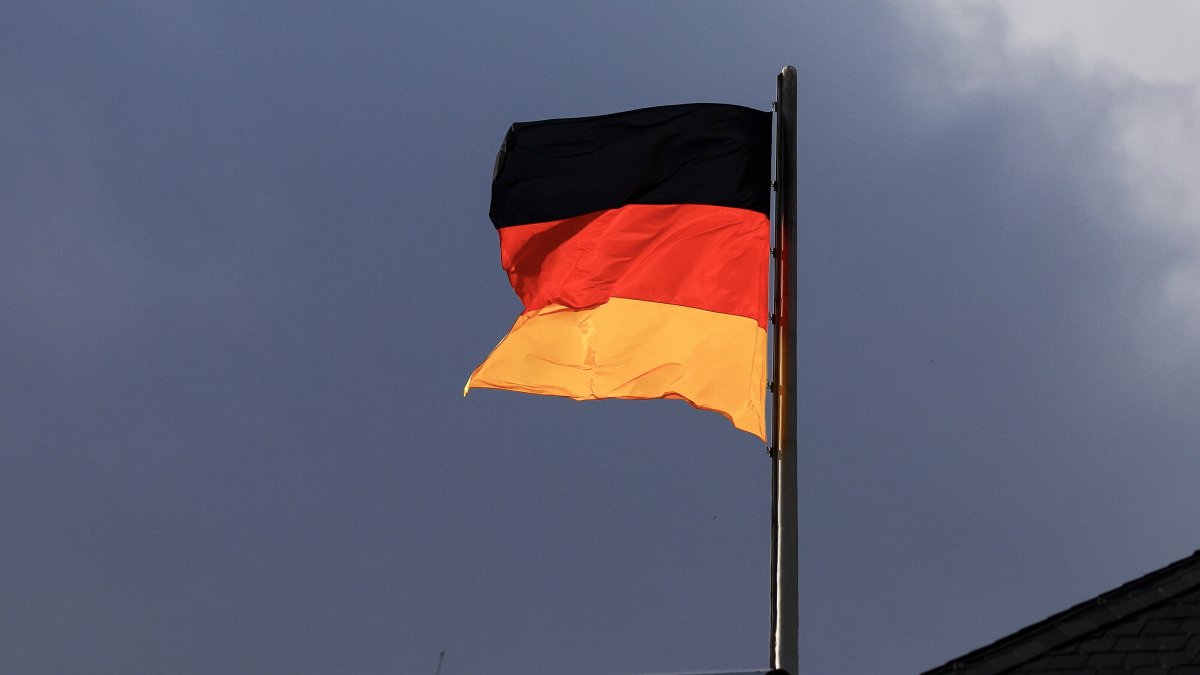 A German flag flutters in the wind atop the German parliament, Bundestag, Berlin, Germany, Nov. 18, 2024. (EPA Photo)