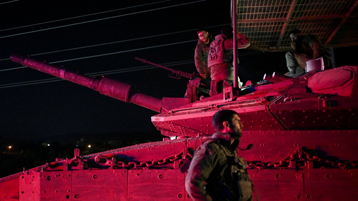 Israeli soldiers gather near a military vehicle after returning from Lebanon, near Kiryat Shmona, northern Israel, Dec. 11, 2024. (Reuters Photo)