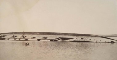 The capsized Ottoman battleship Mesudiye floats on the surface after being struck by torpedos from the British submarine B-11 during World War I. (DHA Photo)
