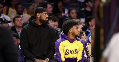 LeBron James (L) and Bronny James of the Los Angeles Lakers look on from the bench in the first half against the Portland Trail Blazers at Crypto.com Arena, Los Angeles, California, U.S., Dec. 8, 2024. (AFP Photo)