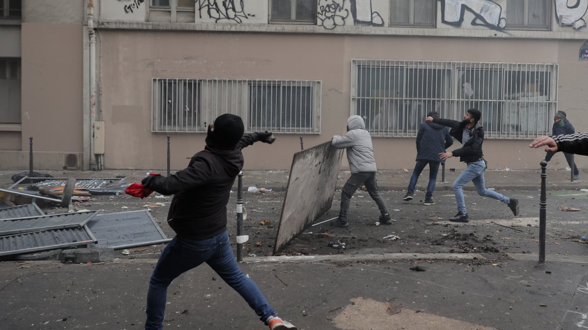 PKK terrorist sympathizers throw objects at police during a riot, Paris, France, Dec. 24, 2022. (AP Photo)