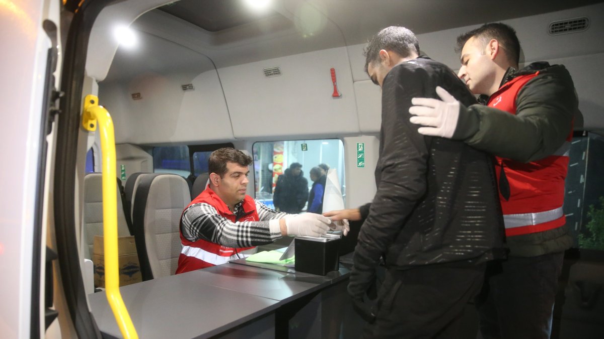 Officials check the identity and fingerprints of a migrant, Edirne, northwestern Türkiye, Dec. 12, 2024. (AA Photo)