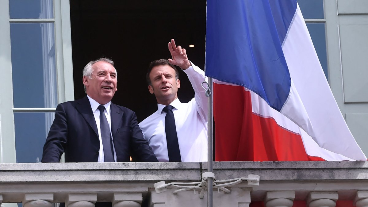 French President Emmanuel Macron (R) poses with Democratic Movement party President Francois Bayrou and Pau Mayor Francois Bayrou (L) on the balcony of the city hall, Pau, France, July 6, 2023. (AFP Photo)