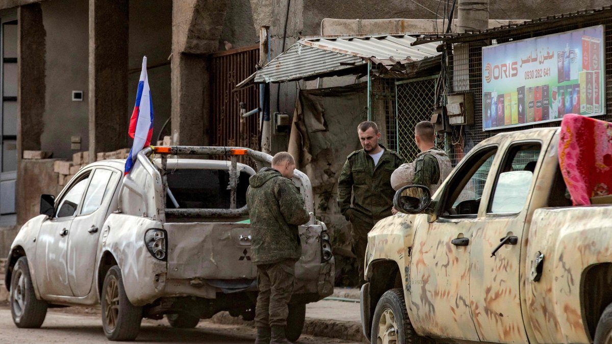 Russian soldiers stand by military pickups as they prepare to evacuate a position in Qamishli in northeastern Syria, Dec.12, 2024. (AFP Photo)