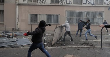 PKK terrorist sympathizers throw objects at police during a riot, Paris, France, Dec. 24, 2022. (AP Photo)