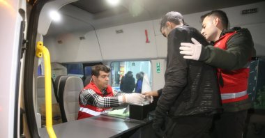 Officials check the identity and fingerprints of a migrant, Edirne, northwestern Türkiye, Dec. 12, 2024. (AA Photo)