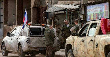 Russian soldiers stand by military pickups as they prepare to evacuate a position in Qamishli in northeastern Syria, Dec.12, 2024. (AFP Photo)