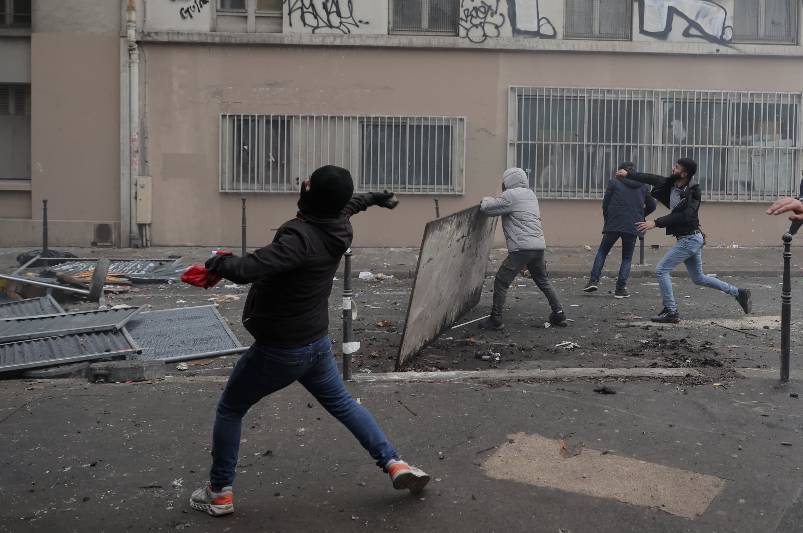 PKK terrorist sympathizers throw objects at police during a riot, Paris, France, Dec. 24, 2022. (AP Photo)