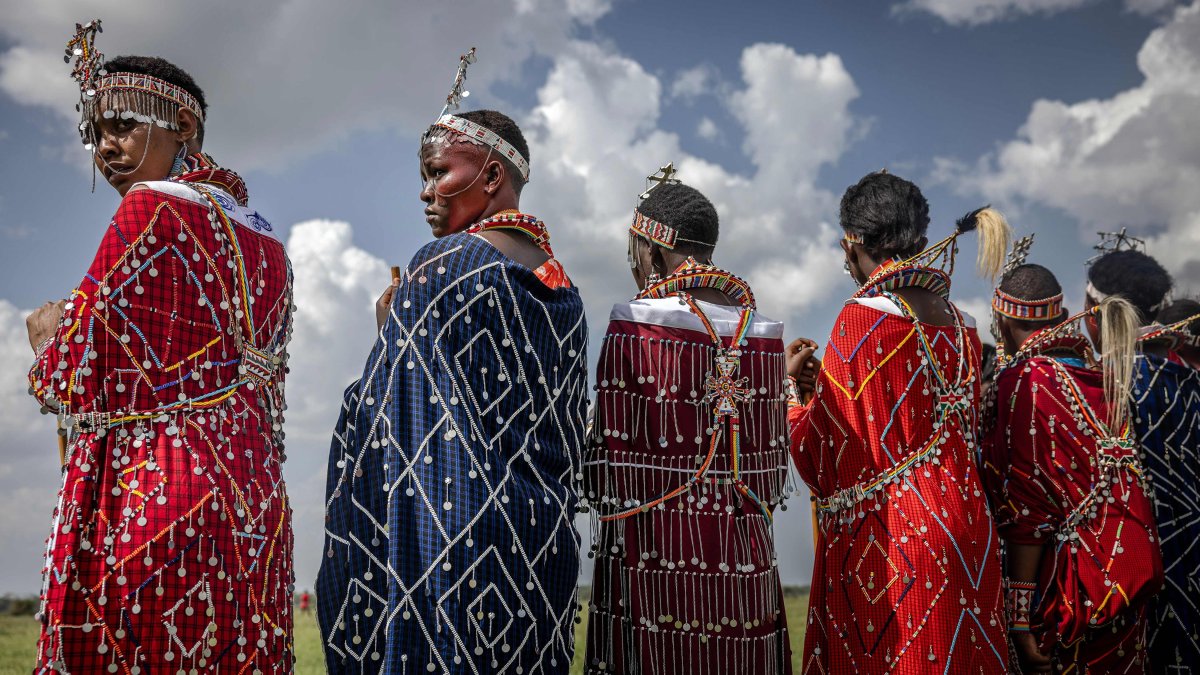 Maasai women dressed in traditional attire watch the competitions from the field at the Maasai Olympics 2024 in Kimana, Kenya, Dec. 14, 2024. (AFP Photo)