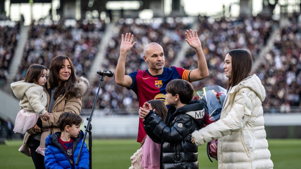 Spanish football legend Andres Iniesta (C) gestures as he is joined by his wife Anna Ortiz and his five children during his retirement ceremony after an exhibition football match in Tokyo, Japan, Dec. 15, 2024. (AFP Photo)