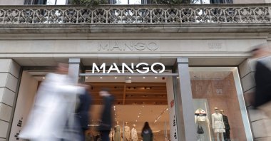 Pedestrians walk by the entrance of a Mango shop on Passeig de Gracia Street, Barcelona, Spain, Feb. 28, 2024. (AFP Photo)