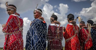 Maasai women dressed in traditional attire watch the competitions from the field at the Maasai Olympics 2024 in Kimana, Kenya, Dec. 14, 2024. (AFP Photo)