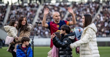Spanish football legend Andres Iniesta (C) gestures as he is joined by his wife Anna Ortiz and his five children during his retirement ceremony after an exhibition football match in Tokyo, Japan, Dec. 15, 2024. (AFP Photo)