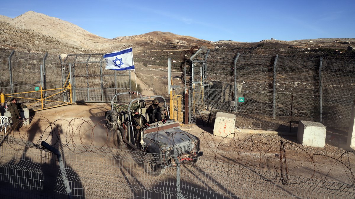 An Israeli military vehicle rides by the cease-fire line between the Israeli-occupied Golan Heights and Syria, Dec. 15, 2024. (Reuters Photo)