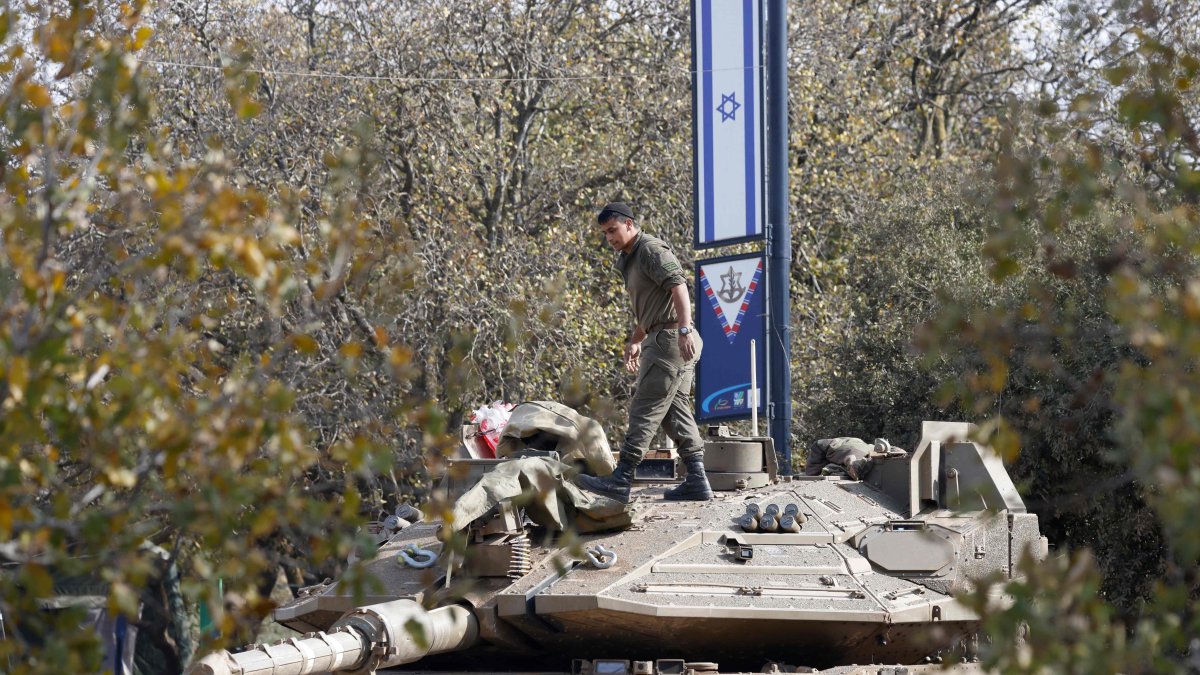 An Israeli soldier arranges gear atop an army tank deployed in the Israeli-occupied Golan Heights around the demilitarized buffer zone in southwest Syria, Dec. 8, 2024. (AFP Photo)