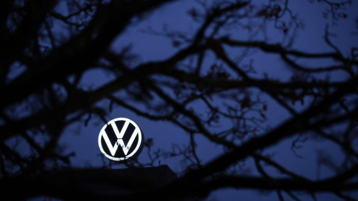 The logo of German carmaker Volkswagen (VW) is seen behind a tree at the company&#039;s headquarters in Wolfsburg, Germany, Dec. 4, 2024. (AFP Photo)