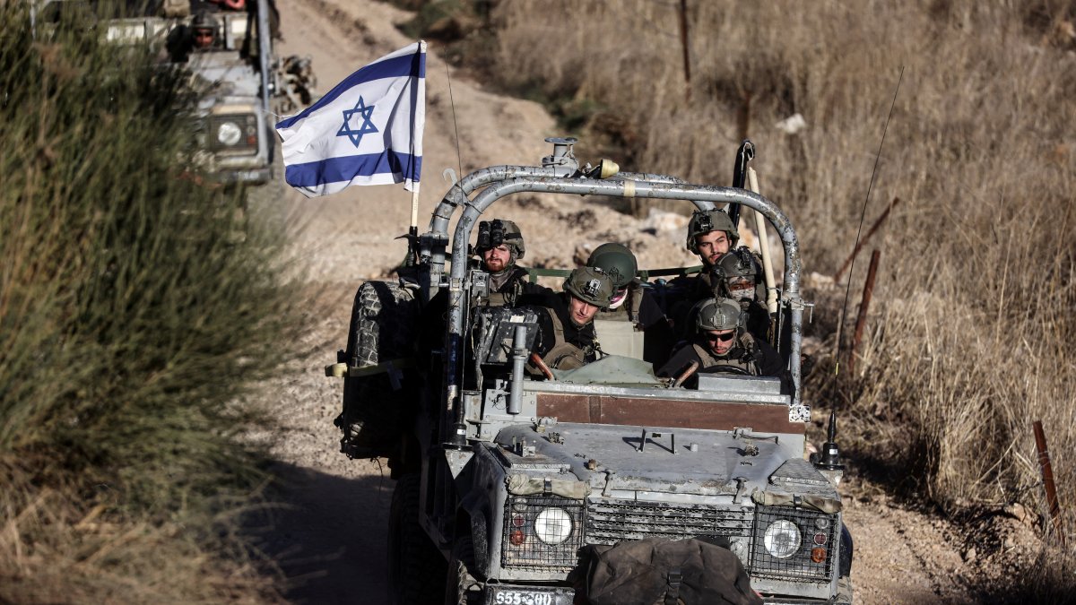 Israeli military vehicles drive close to the cease-fire line between the Israeli-occupied Golan Heights and Syria, as seen from Majdal Shams in the Golan Heights, Syria, Dec. 15, 2024. (Reuters Photo)