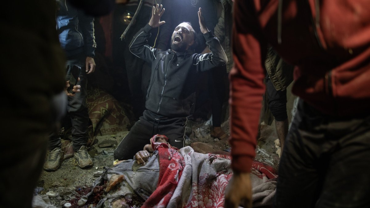 A Palestinian man reacts next to a body among debris at the site after an Israeli airstrike hit a UNRWA-run school sheltering displaced people, in Khan Younis, southern Gaza Strip, Palestine, Dec. 15, 2024. (EPA Photo)